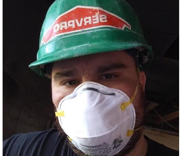 Photo shows an employee wearing PPE